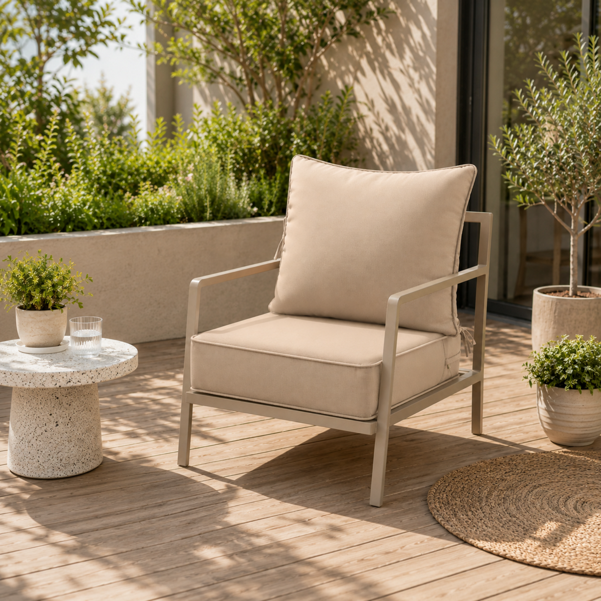 Beige water-resistant patio chair cushion with secure ties on a modern outdoor metal chair on a wooden deck.